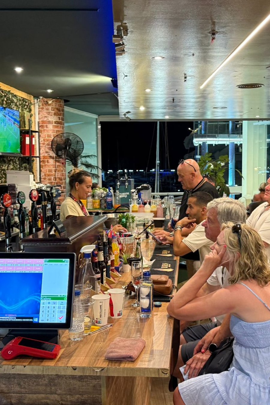 Inside the games room: bar, screens and pool at MT Pockets, Puerto Marina